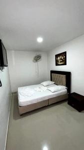 a bedroom with a bed in a room at Hotel Imperio in Ibagué