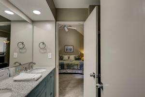 a bathroom with a sink and a mirror and a bed at Luxury 3 BR Condo at 569 Queens Grant Updated kitchen and baths 2 Kings Queen Double Twin & Sleeper in Hilton Head Island +19 photos