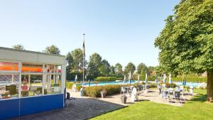 a building with tables and chairs in a park at Tussen de Diepen in Blokzijl