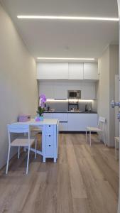 a kitchen with a blue table and chairs in a room at Vespucci Guest House in Pescara