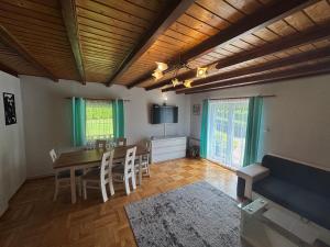 a living room with a table and chairs and a tv at U Małgorzaty in Wojtkowa
