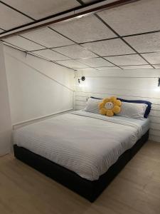 a teddy bear sitting on top of a bed at LA CASA in China town in Bangkok +63 photos