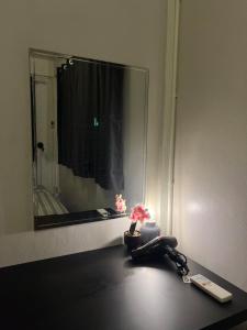 a room with a mirror and a phone on a table at LA CASA in China town in Bangkok +65 photos