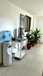 a room with a table with a drink mixer and plants at Hotel Imperio in Ibagué