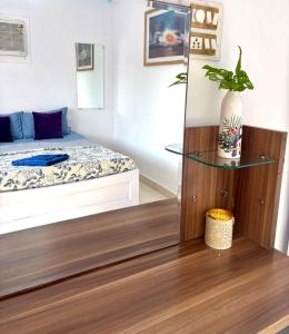 a bedroom with a bed and a glass table at Topaz -Sunkissed Holidays Goa in Candolim