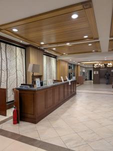 a lobby with a reception desk in a building at The Cozy Hub in Baguio
