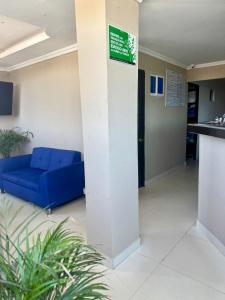 a lobby with a blue couch in a building at hotel gloria del norte sas in Cartagena de Indias
