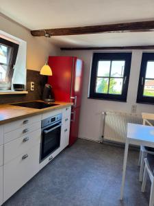 a kitchen with a red refrigerator and a table at Nr7 Das Ferienhaus in Hameln +13 photos