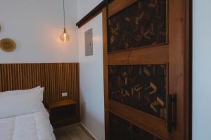 une chambre avec une porte en bois et un lit dans l'établissement Apartamentos Santa Delfina 2, à Flores