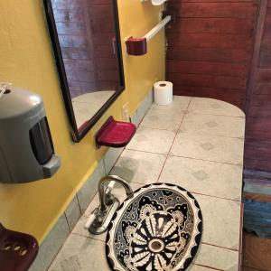 a bathroom with a sink and a mirror at ecohabitas in Mazunte +35 photos