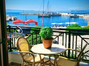 a table with a potted plant on a balcony at Anna Maria - Vanessa Apartments in Neo Klima +262 photos