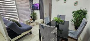 a dining room with a table and chairs and plants at Familiar Departamento 3 dorm 2 baños in Rancagua
