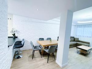 a dining room with a table and chairs and a couch at Harmony by the Sea in Cambrils