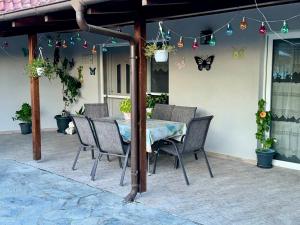 a table and chairs on a patio with butterfly decorations at Zwergendorf in Chaïdeftón