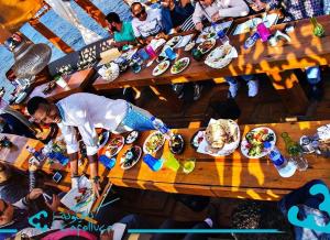 a group of people sitting at a table with plates of food at Pyramids old stone hotel in Cairo