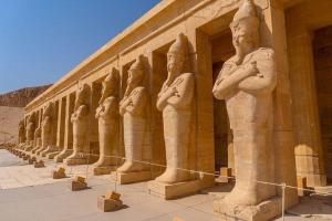 a row of statues on the side of a building at Pyramids & SphinX Grand Hotel in Cairo