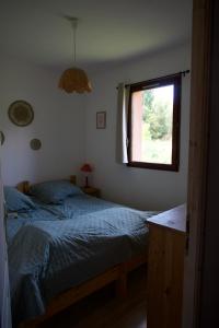 a bedroom with a bed and a window at La bulle - Font-Romeu in Font-Romeu