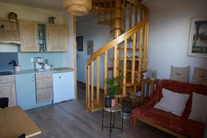 a living room with a spiral staircase and a kitchen at La bulle - Font-Romeu in Font-Romeu +22 photos