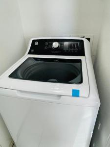 a white microwave oven sitting in a corner at Stunning Home in Plano! in Plano
