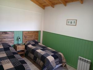 two beds in a room with green walls at El Cardon in Sierra de la Ventana +22 photos