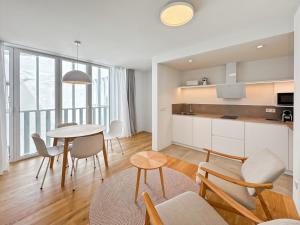 a kitchen and dining room with a table and chairs at housingcoruña RUA DO ANXO in A Coruña
