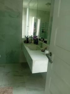 マラゴージにあるCasa jardinsの洗面台が2つと鏡があるバスルーム +21枚の写真