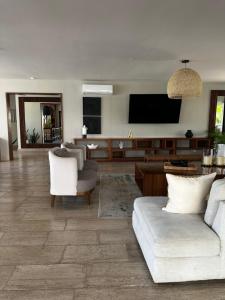 a living room with a couch and a flat screen tv at Vela Towers in Cancún