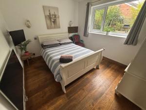 a bedroom with a white bed and a window at Pet Friendly House with Hot tub in Hale in Moffat