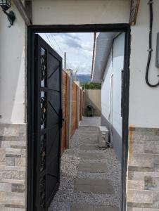 an open door to an alley with a pathway at Cabaña sopetran in Sopetran