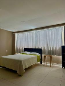 a bedroom with a bed and a large window at hotel gloria del norte sas in Cartagena de Indias