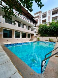 a swimming pool in front of a building at Marvella Stays in Anjuna