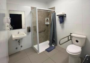 a bathroom with a shower and a toilet and a sink at The Hostel Santiago in Santiago