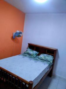 une chambre avec un lit en bois dans une pièce dans l'établissement Baobab immobilier Thiès, à Thiès