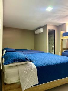 a bed with blue and white pillows in a room at hotel gloria del norte sas in Cartagena de Indias +16 photos