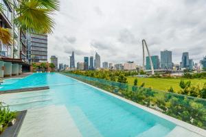 a swimming pool with a city skyline in the background at Lè Métropole Saigon in Ho Chi Minh City +82 photos