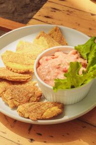a plate with a bowl of dip and tortilla chips at Casa Chapolin Boutique Guesthouse in Palomino