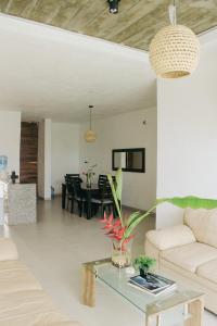 a living room with a couch and a table at Casa Calec 2BR Apartment with Pool & Terrace in Manzanillo