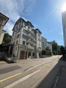 a large white building on the side of a street at M&S Apartments - St Gallen City - 5 min Bahnhof in St. Gallen