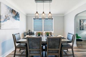 a dining room with a table and chairs and a window at Outdoor Sauna Hot Tub Playroom Port Dallhousie in St. Catharines
