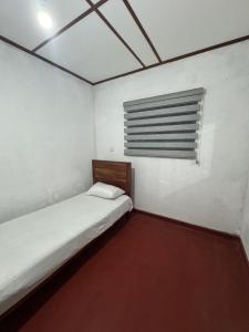 a small room with a bed and a window at Seliya Villa Retreat in Balapitiya