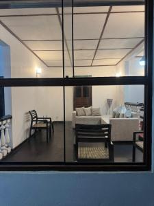 a view of a living room through a window at Seliya Villa Retreat in Balapitiya