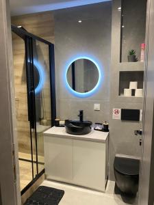 a bathroom with a sink and a mirror at Crystal Grey Elite Apartment 2 in Serres
