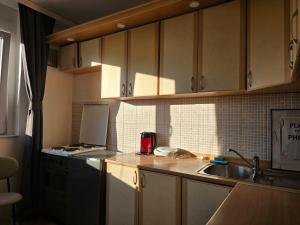 a kitchen with a sink and a counter top at City Haven Prishtina in Pristina