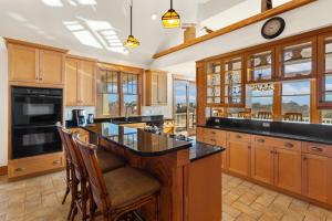 a kitchen with wooden cabinets and a large island at 1812 - The Original Sound and the Fury in Poplar Branch