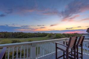 two chairs sitting on a balcony watching the sunset at 1812 - The Original Sound and the Fury in Poplar Branch