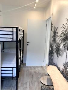a room with two bunk beds and a door at GardaEssence in Peschiera del Garda