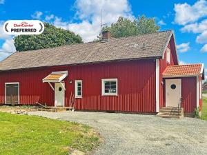 a red barn with a red roof at 4 person holiday home in ANEBY-By Traum in Aneby +11 photos