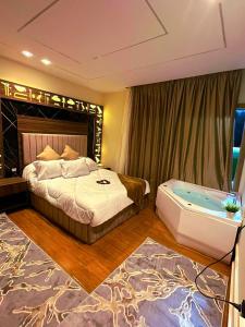 a bedroom with a bed and a bath tub at Pyramids old stone hotel in Cairo