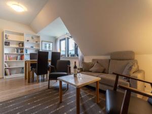 a living room with a couch and a table at Ferienwohnung Küstenluft in Tating in Tating
