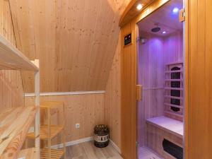 a wooden cabin with a staircase in a room at Ferienwohnung Küstenluft in Tating in Tating +17 photos